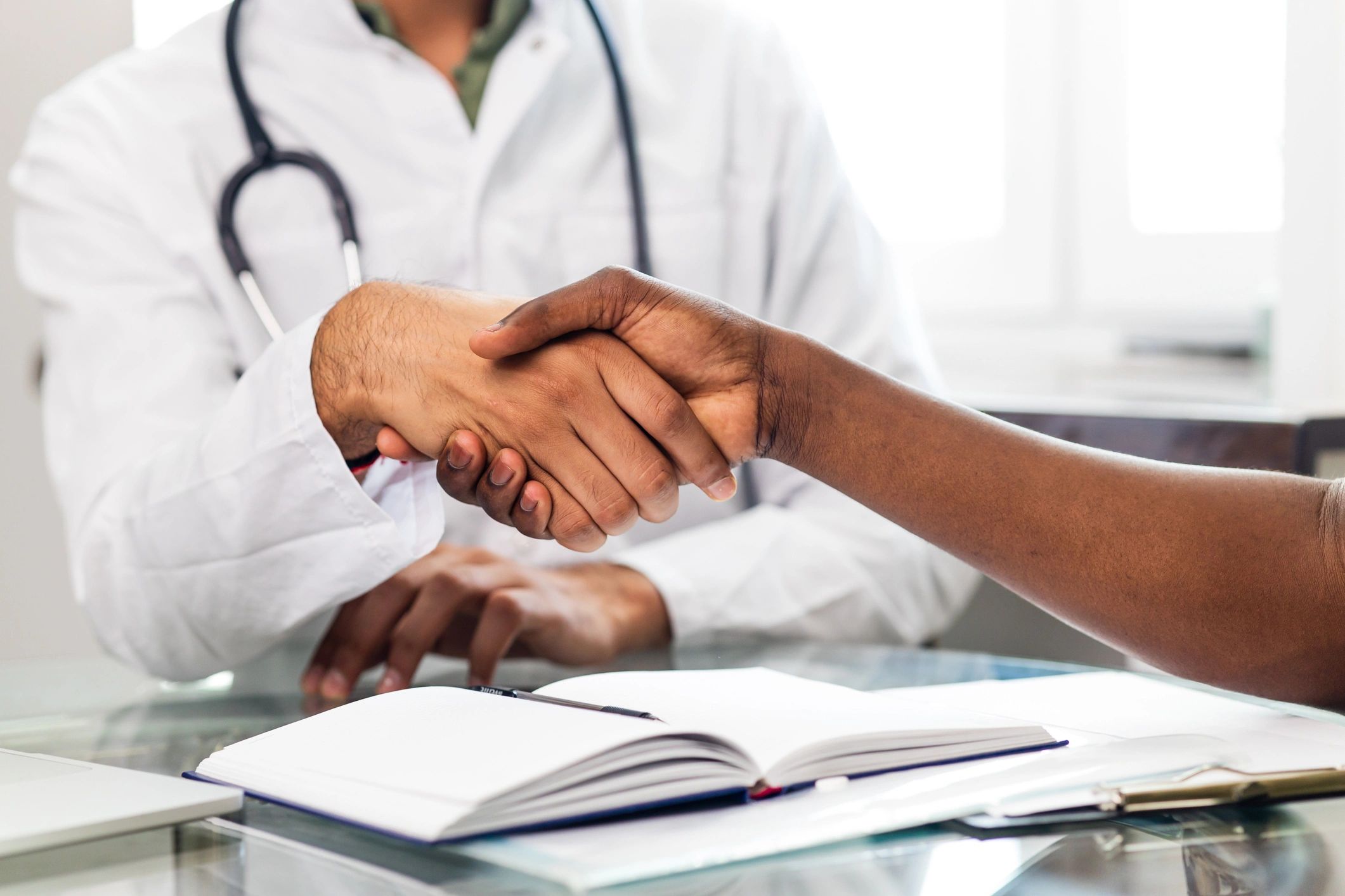 Doctor holding a patient’s hand in support