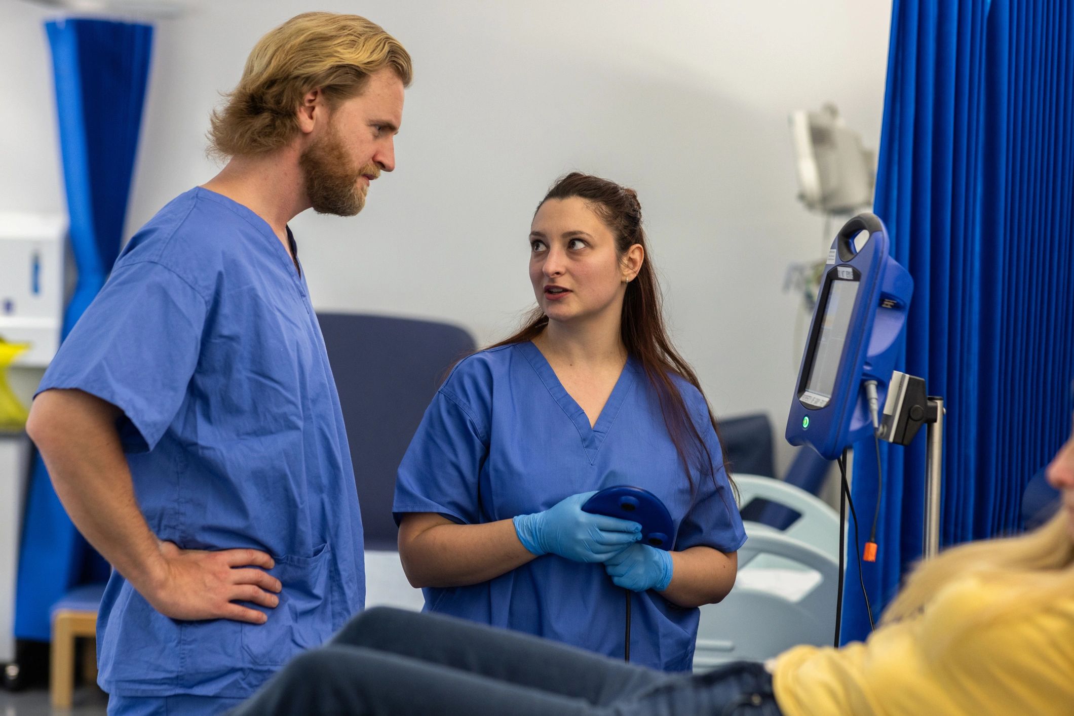 Doctor teaching a trainee in a clinical setting